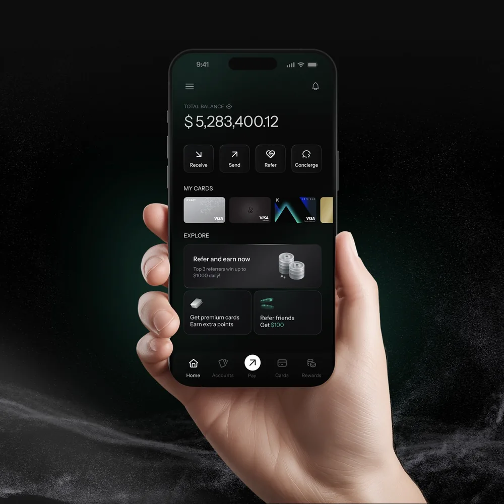 Hand holding an iPhone with the KAST app home screen