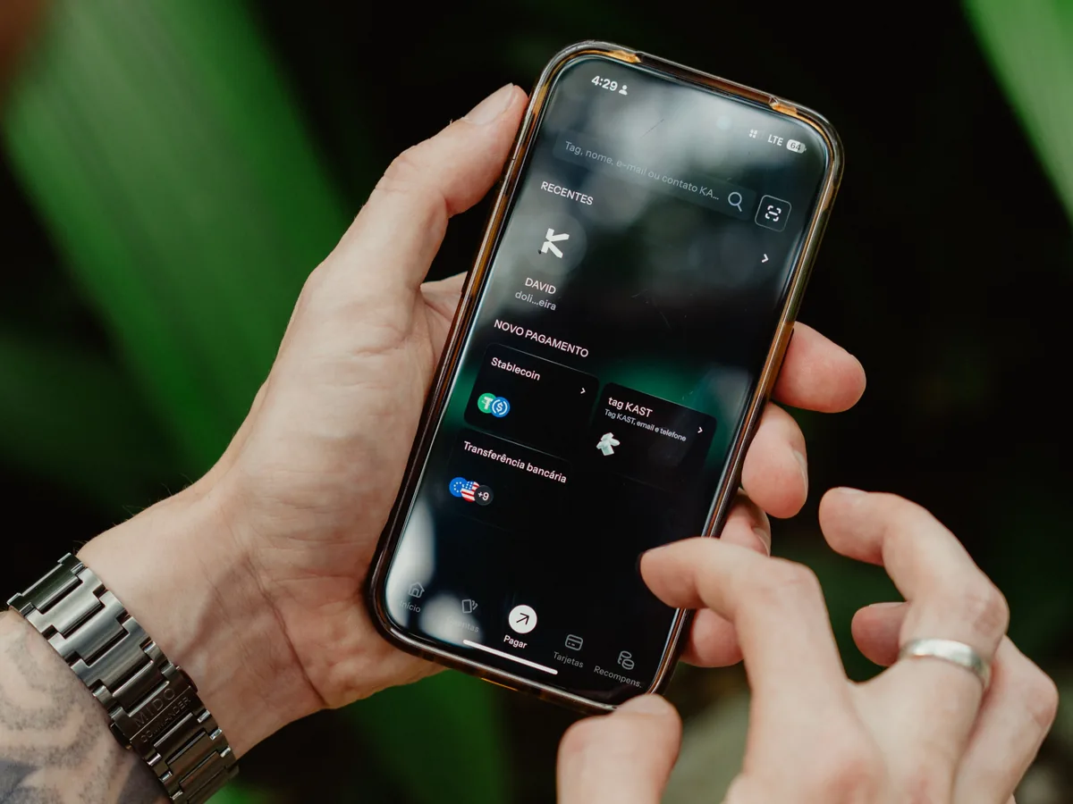 Hands holding a phone with the KAST send screen