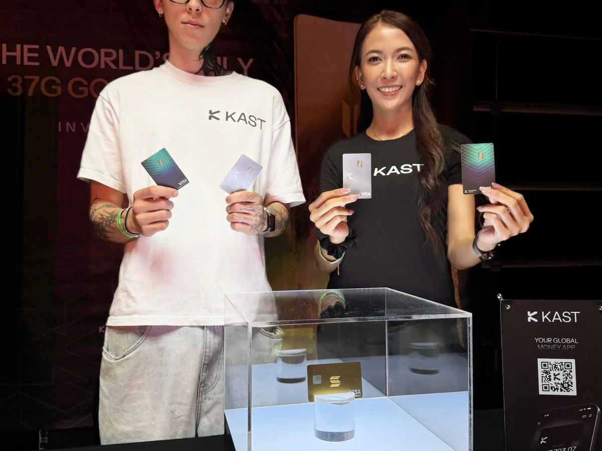 KAST staff holding cards at the KAST booth, Korea Blockchain Week 2025
