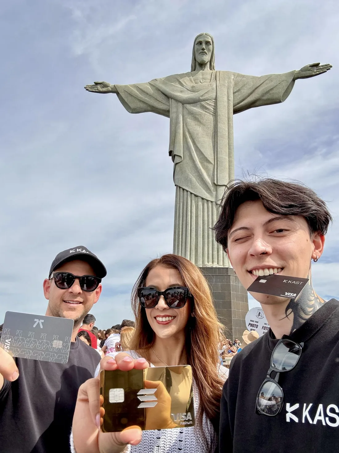 KAST cards held up in front of Christ the Redeemer in Rio de Janeiro