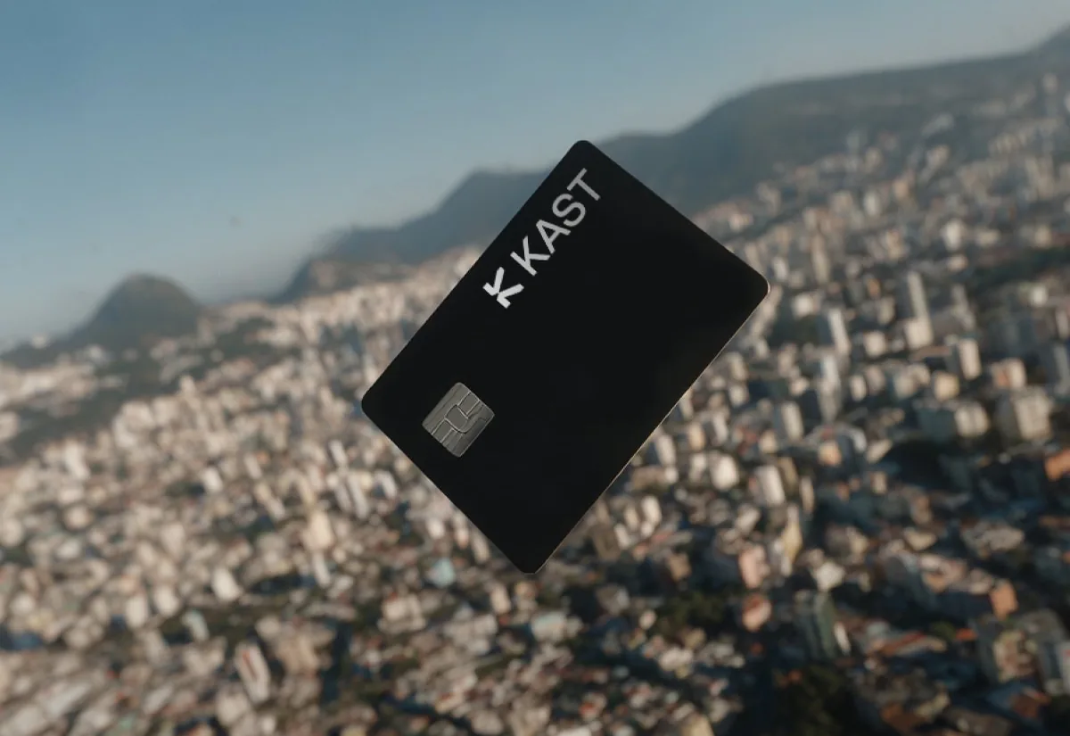 Black KAST card over an aerial view of Rio de Janeiro, Brazil