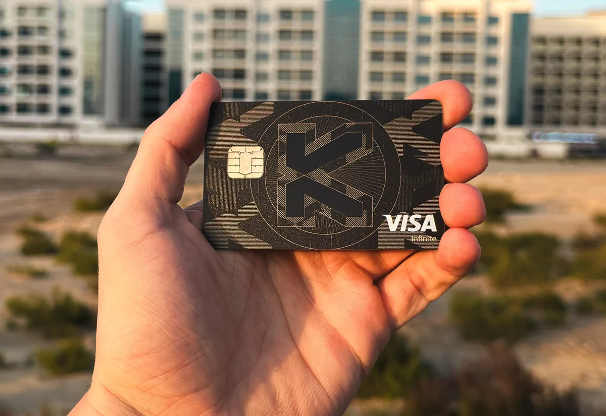 KAST card held up in front of buildings in Dubai, UAE