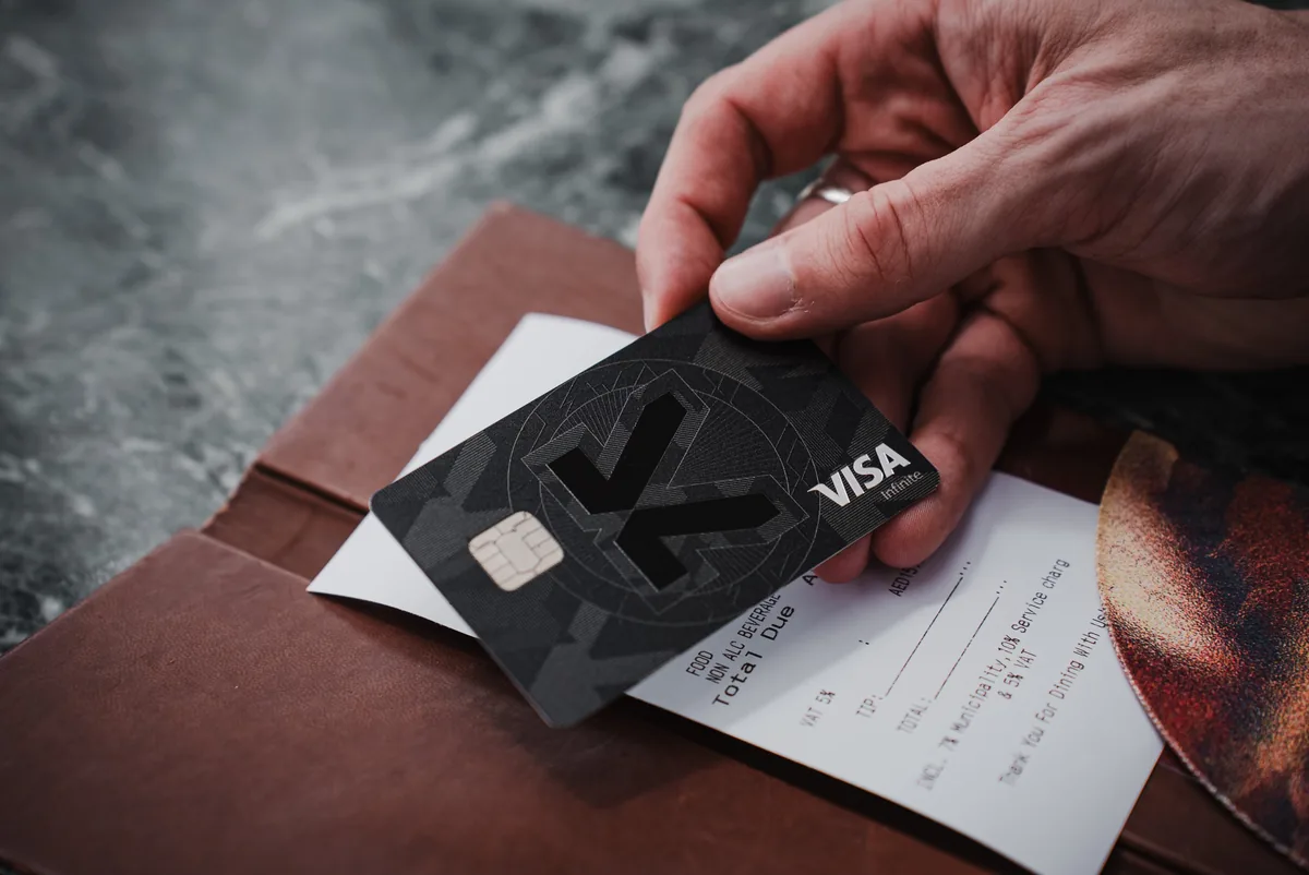 KAST Founders card handed over on a restaurant bill