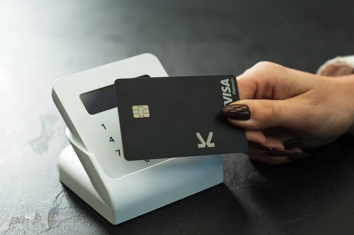 Black KAST Visa card tapped on a card reader