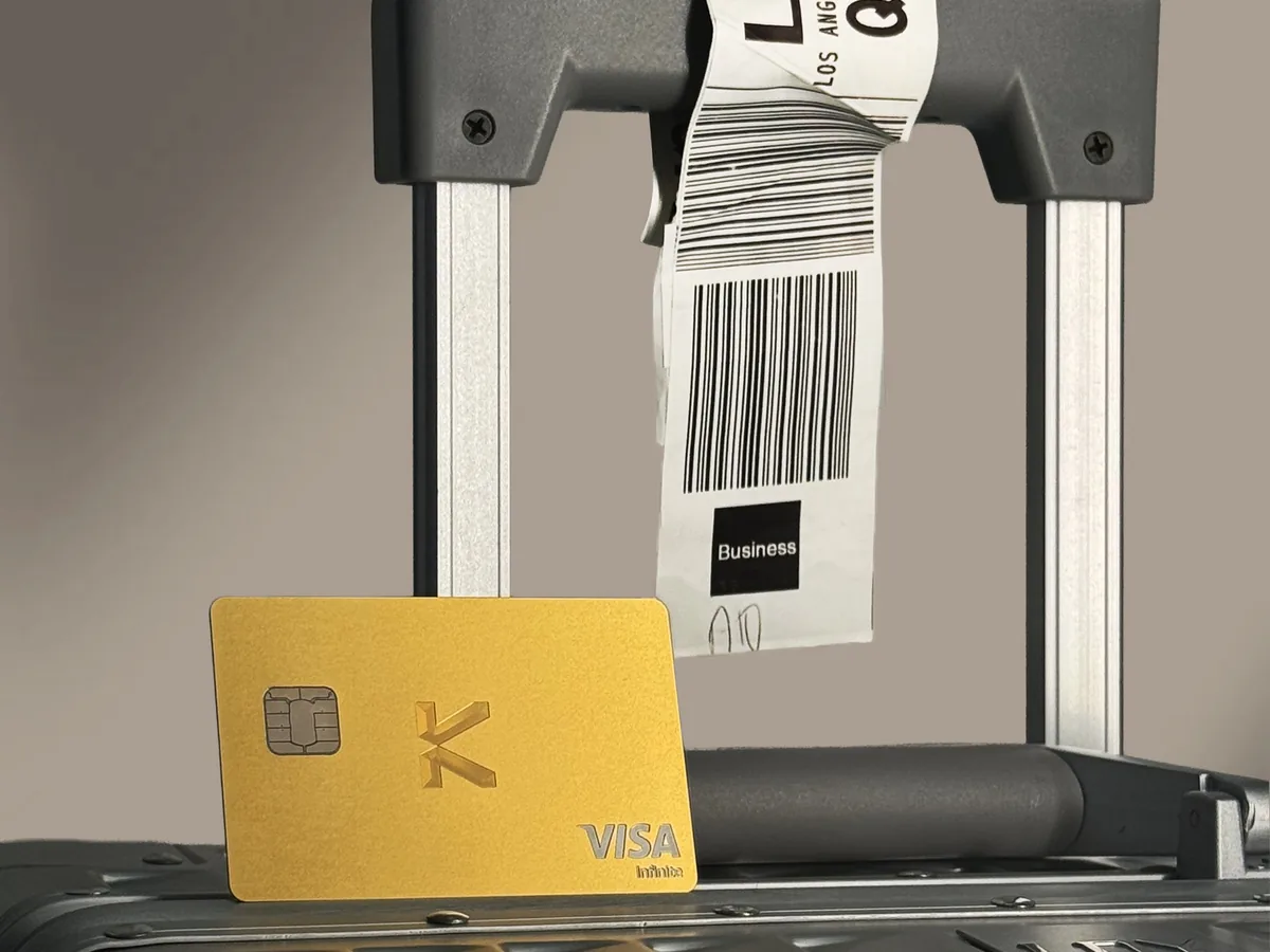 Gold KAST card on a suitcase handle, booking flights from Pakistan