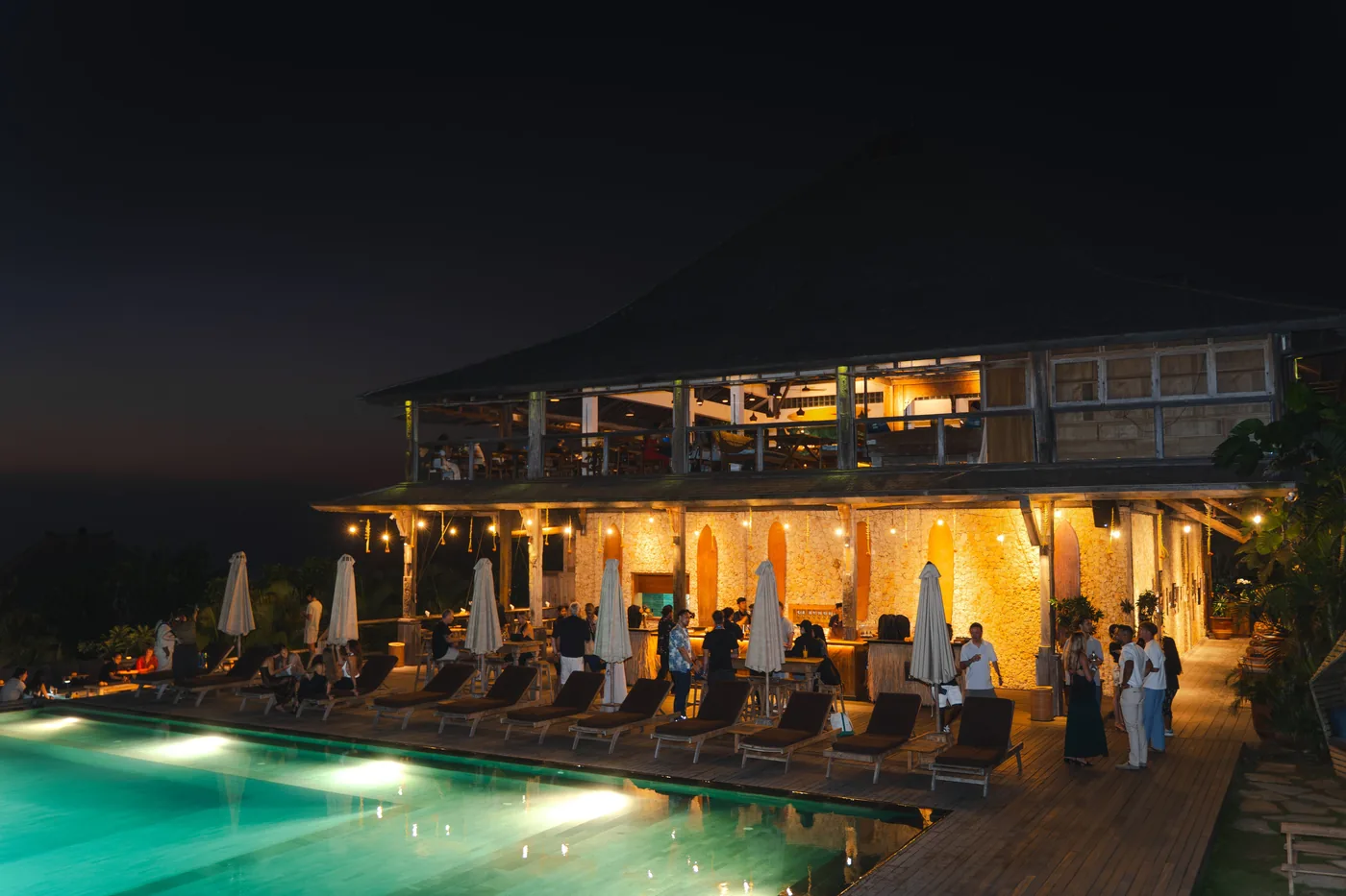 Beach club pool and restaurant at dusk in Bali, Indonesia