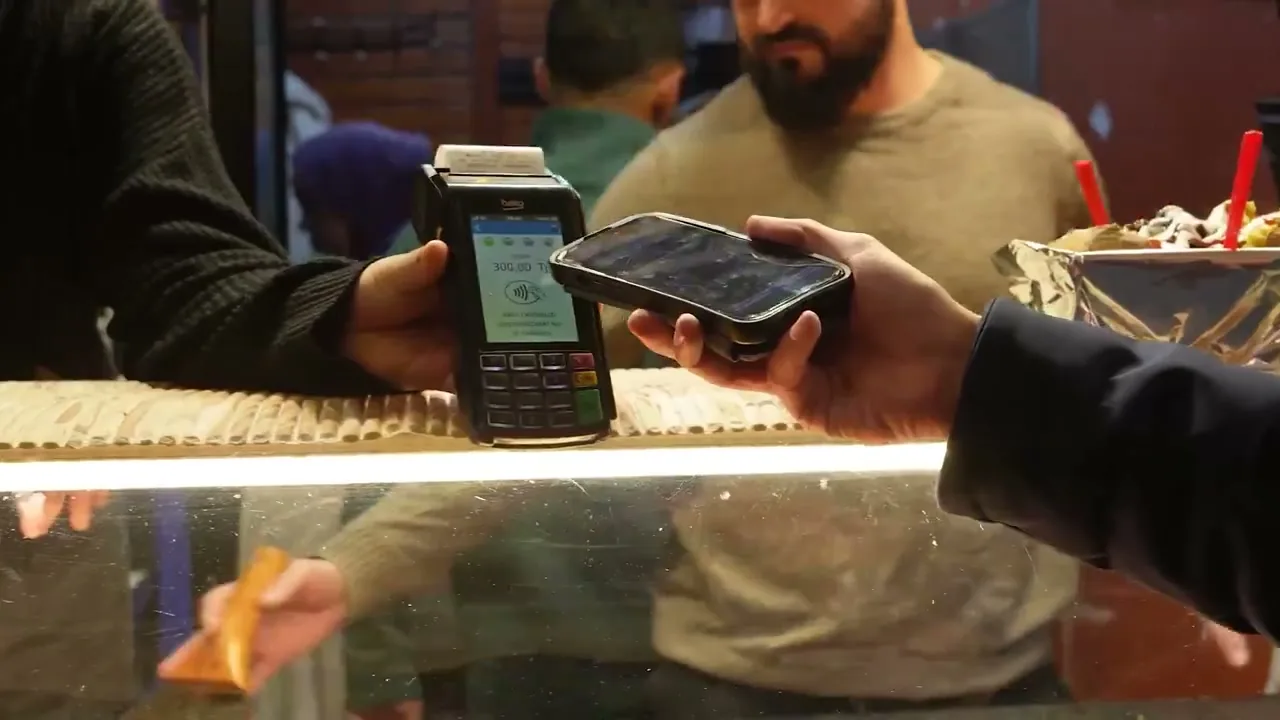 Paying by phone at a shop in Istanbul