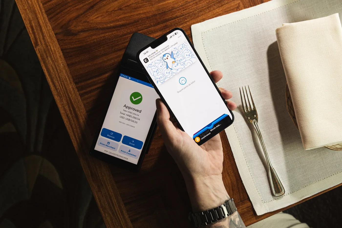 Phone payment approved at a card terminal on a restaurant table