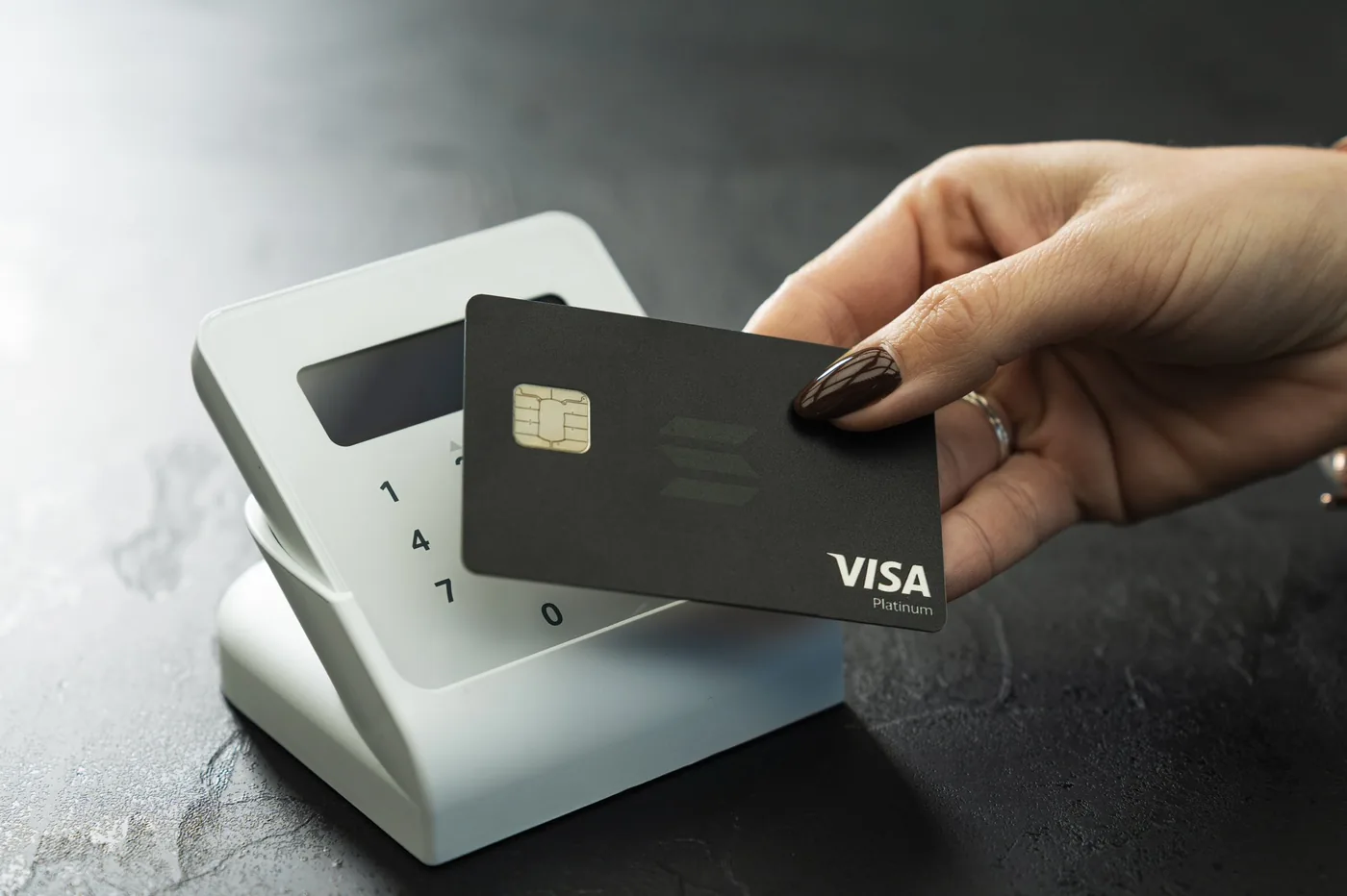 Black KAST Solana Visa card tapped on a card reader