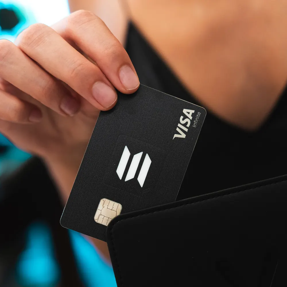 Black KAST Solana Visa card pulled from a wallet