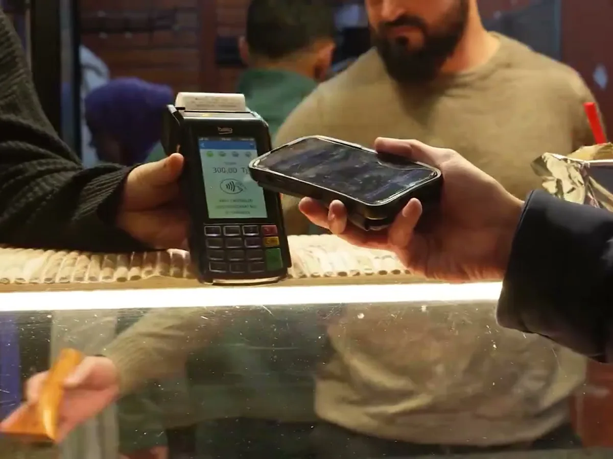 Paying by phone at a shop card terminal in Istanbul