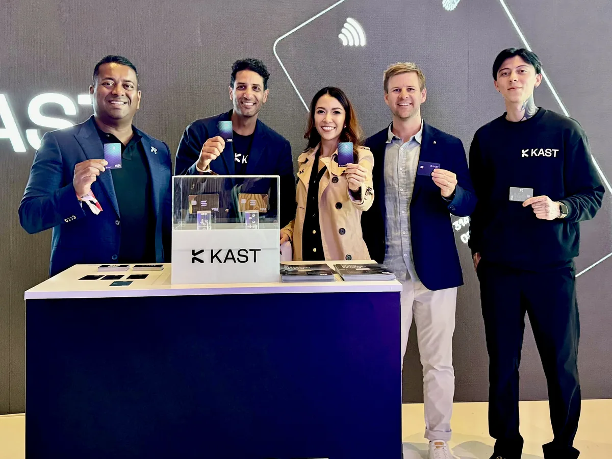 KAST team holding cards at the Solana Crossroads booth in Istanbul