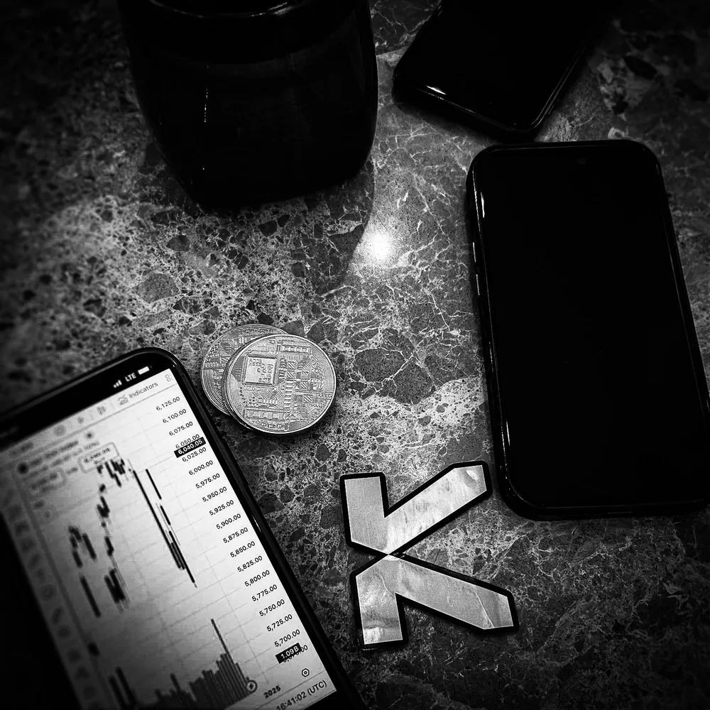 KAST coin beside phones showing a trading chart