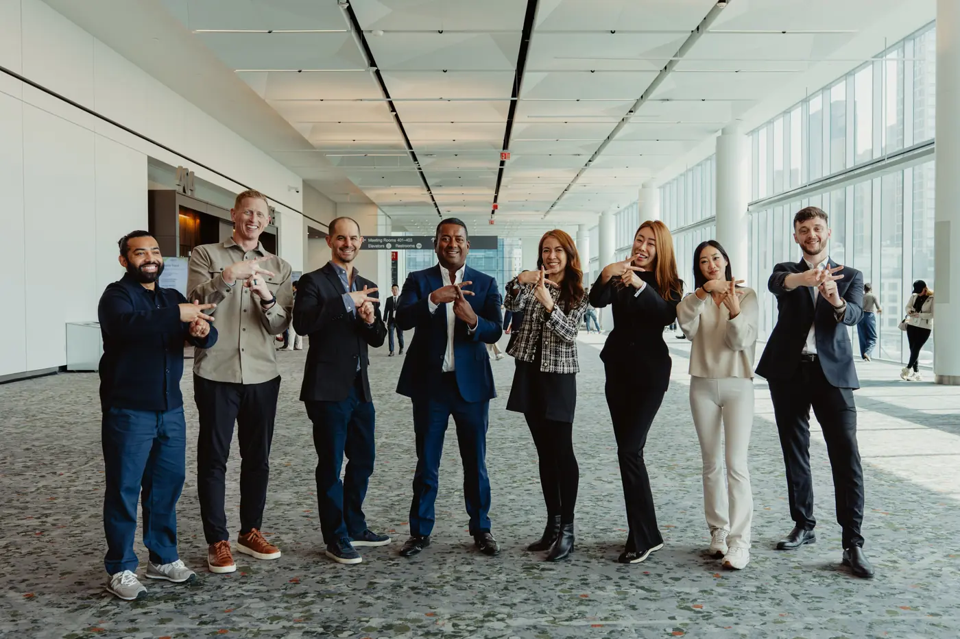 KAST team making the K hand sign at Digital Asset Summit New York 2026