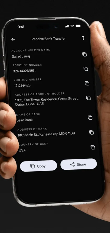 Hand holding a phone with KAST USD bank transfer details and Copy and Share buttons