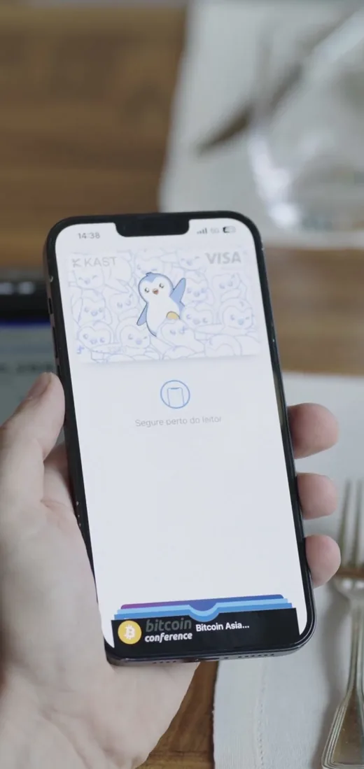 KAST card in Apple Wallet on an iPhone, ready to tap at a contactless terminal